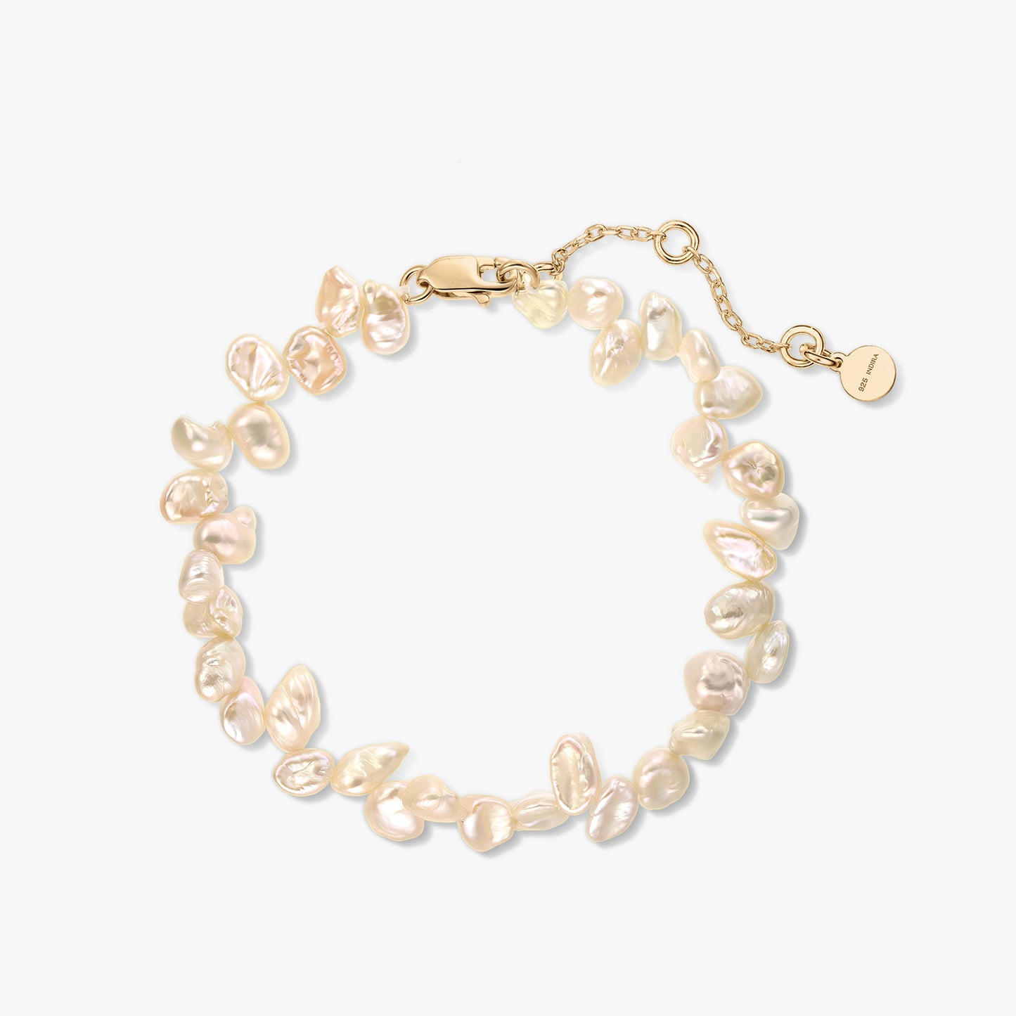 Gold‑plated sterling silver bracelet with natural pink keshi pearls and extender chain on a white background.