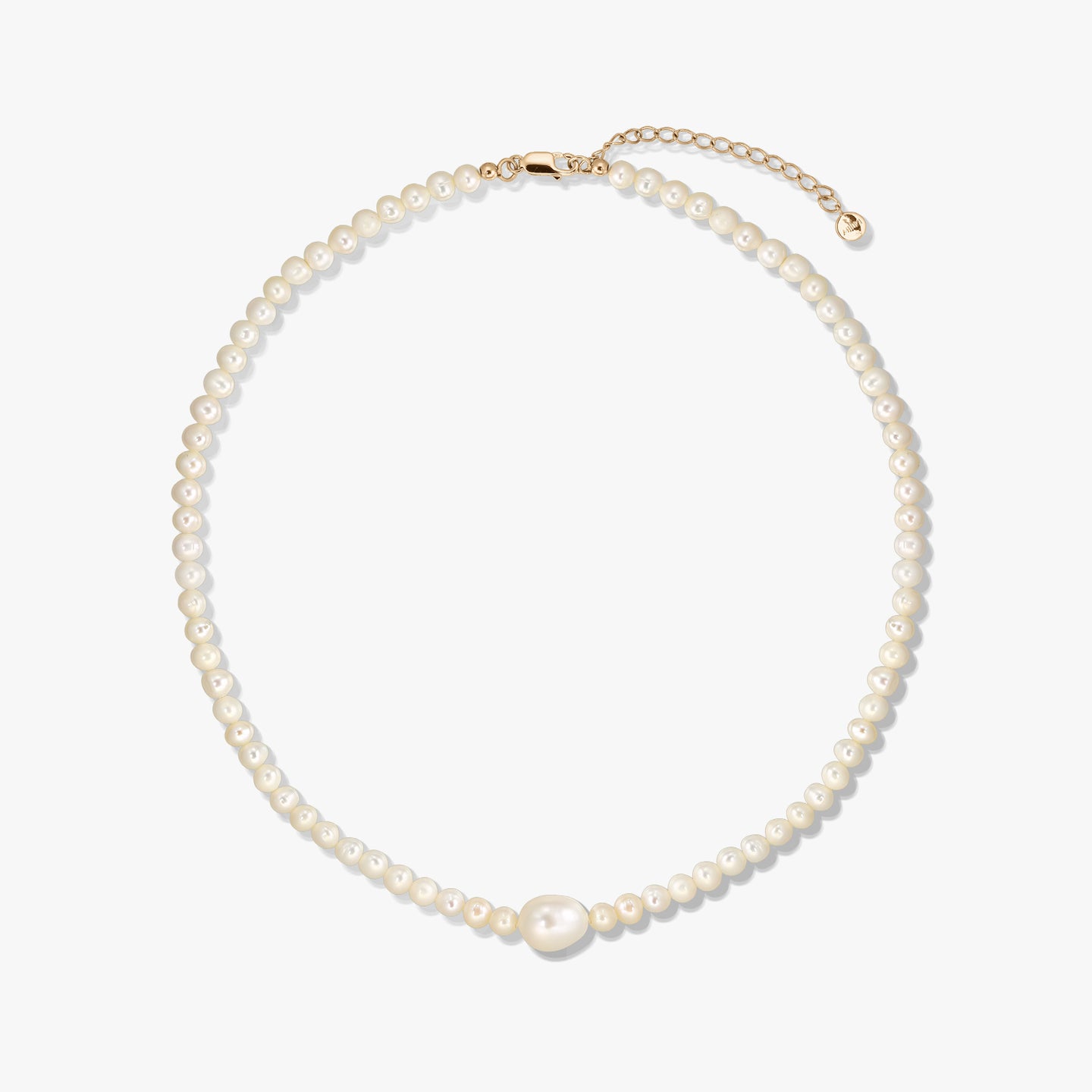 Golden Chanti silver necklace with white cultured pearls and an adjustable extender chain on a white background.