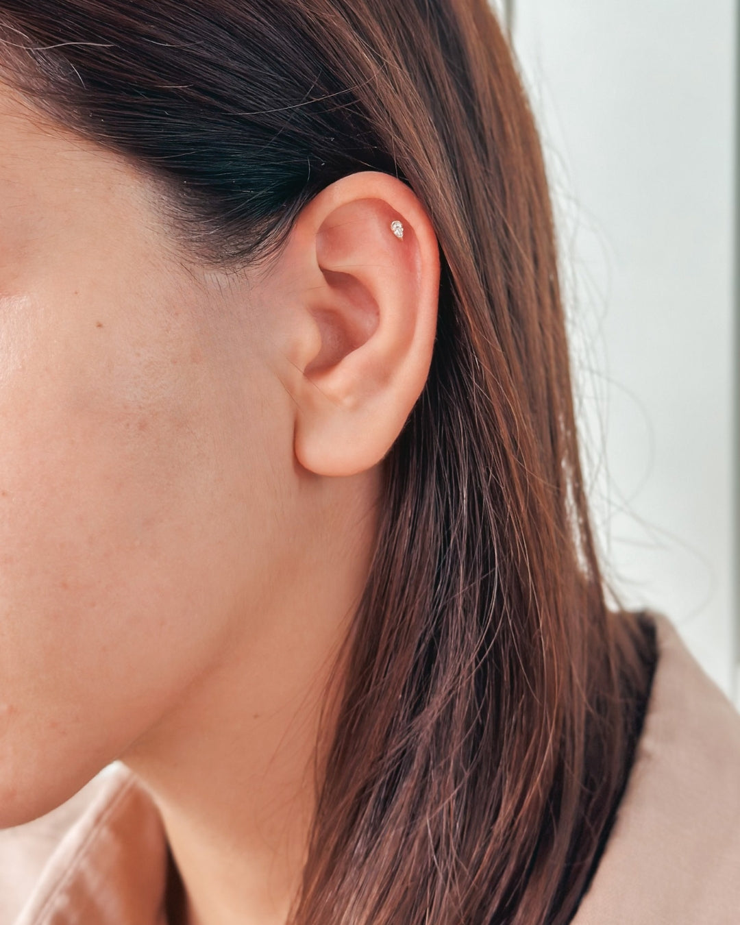 Close-up of an ear with a small stud earring
