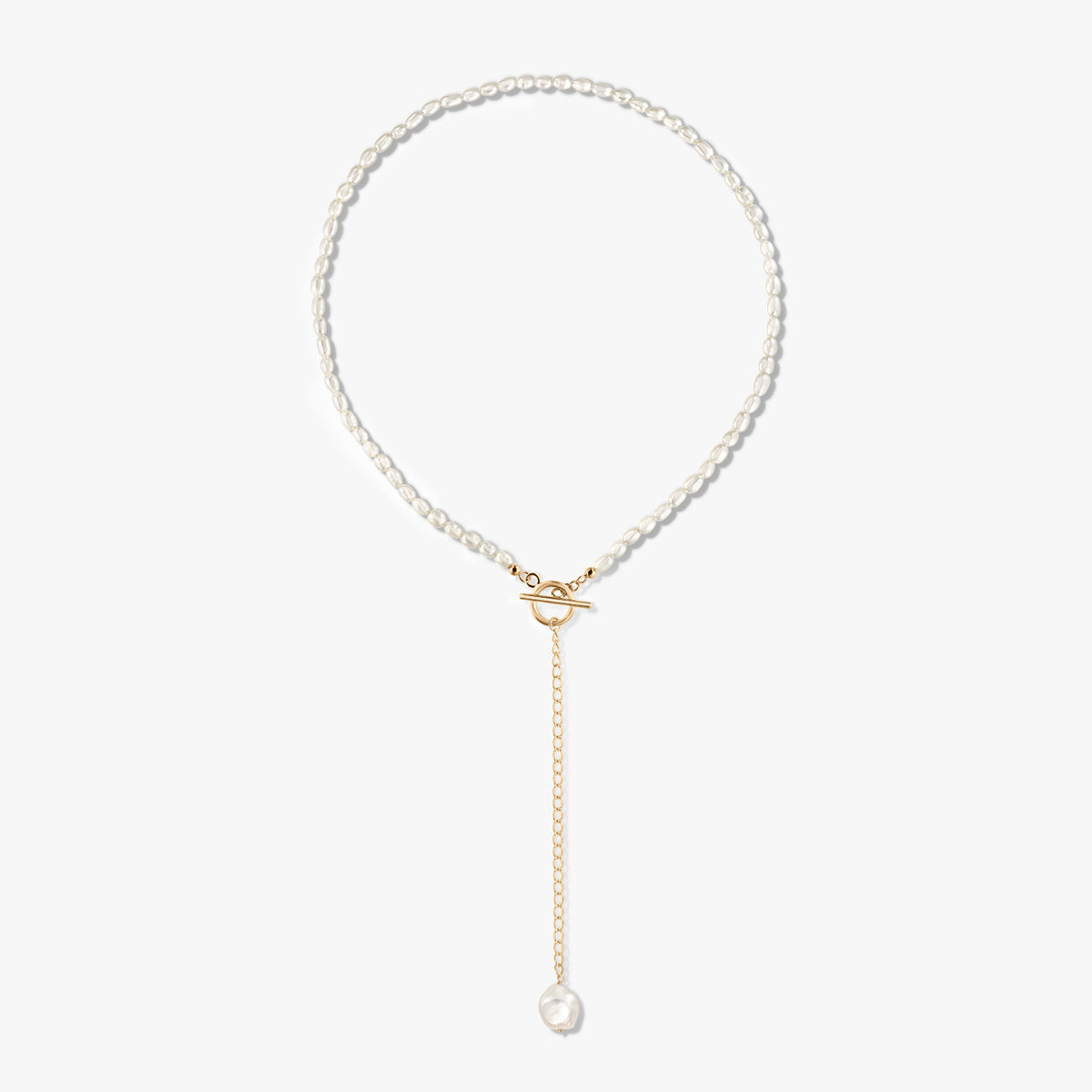 Golden Jacqueline 14K gold‑plated sterling silver pearl necklace with front toggle clasp and a gold drop chain ending in a single pearl, on a white background.