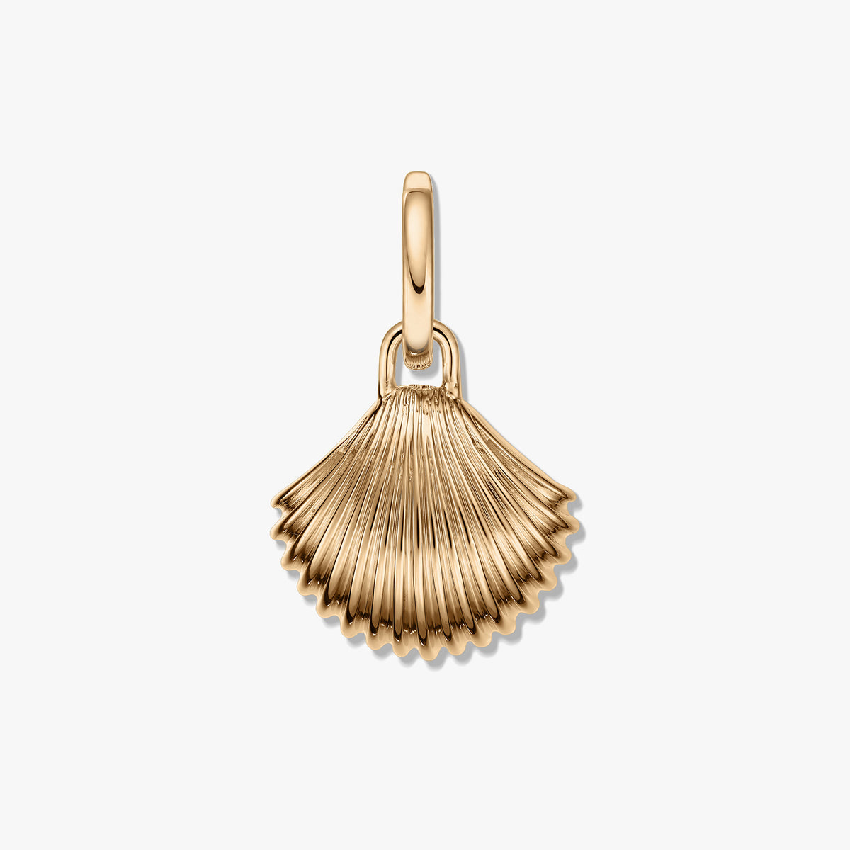 Golden shell-shaped pendant with ribbed texture and a polished gold‑tone finish on a white background.