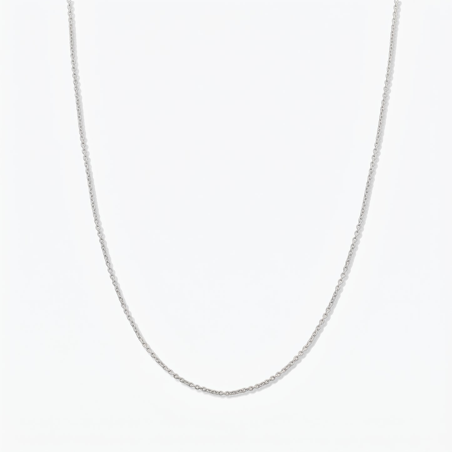Simple sterling silver chain necklace photographed on a white background.