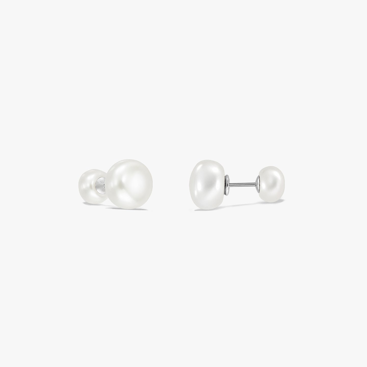 Pair of sterling silver double pearl stud earrings on a white background, each with a large white natural pearl on one end and a smaller pearl on the other connected by a post.