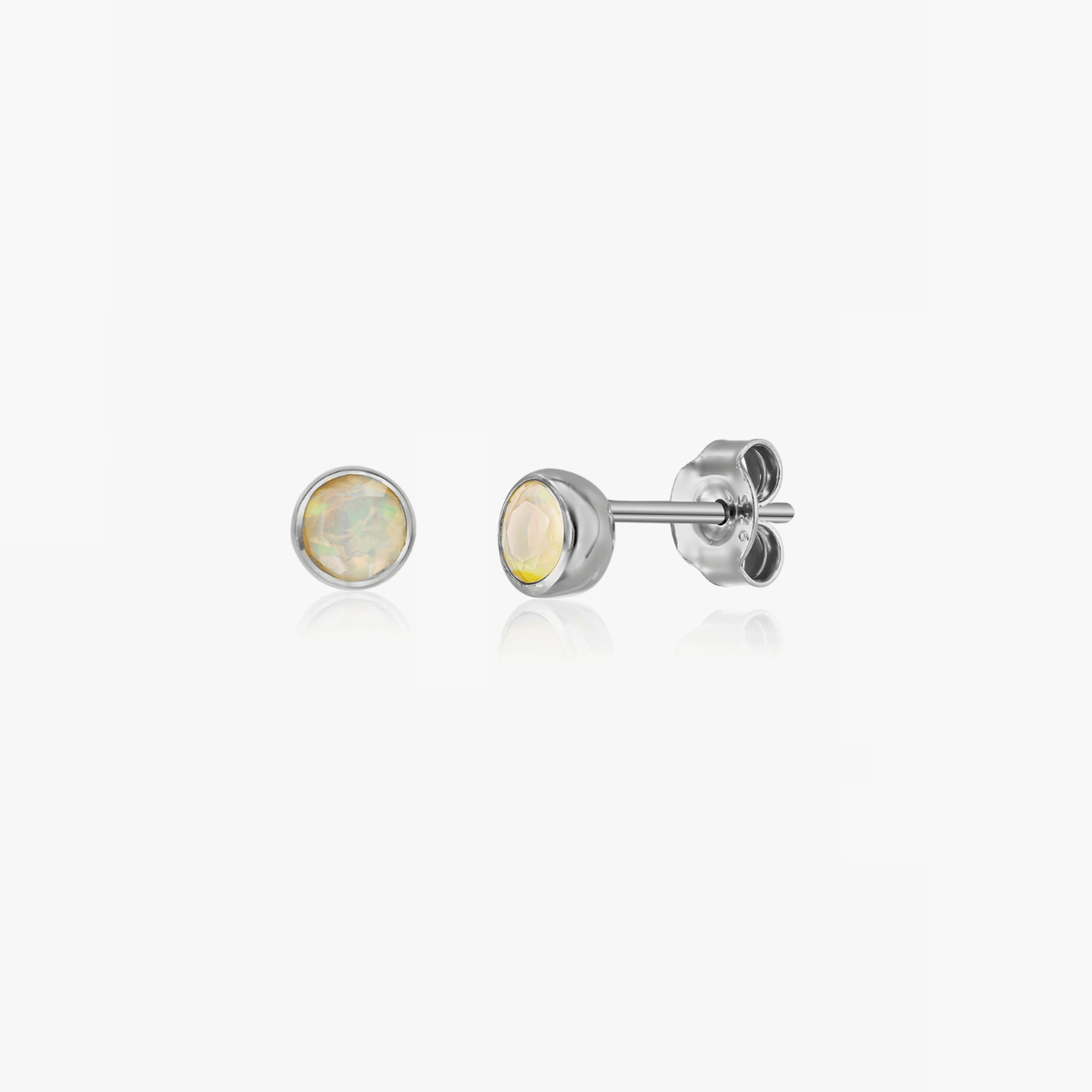 A pair of silver earrings with opal gemstone, designed as birthstone studs for October.