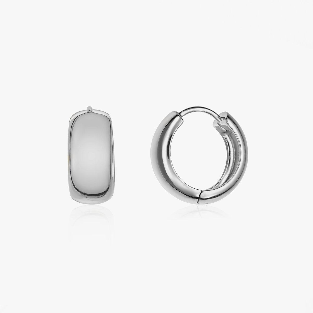 Pair of bold silver hoop earrings on a white background.