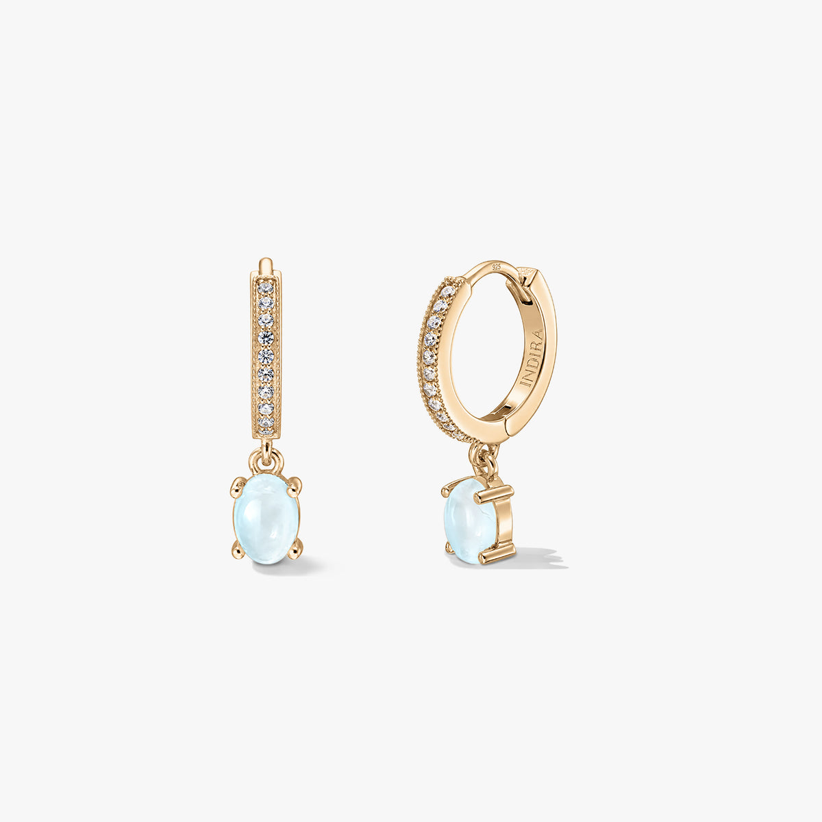 Indira Golden Gem Huggies silver earrings with oval moonstone drops and pavé-set hoops, shown on a white background in front and side views.