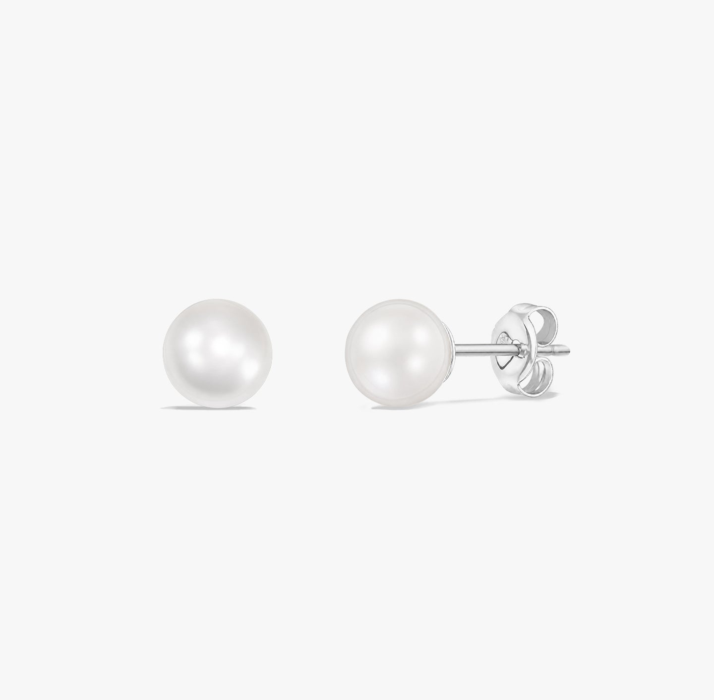 Pair of classic pearl stud earrings with natural white pearls set in 925 sterling silver on a white background.