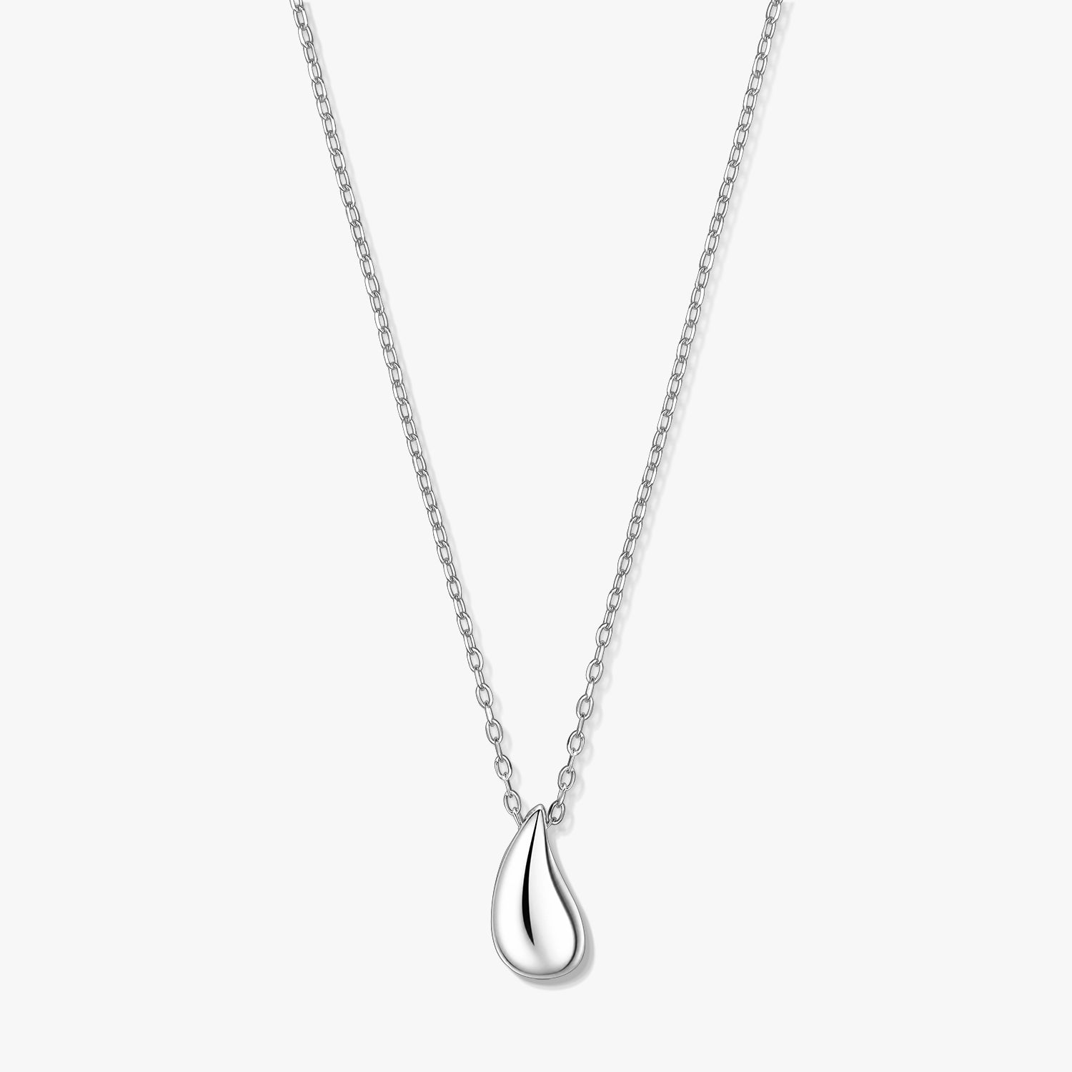Silver teardrop pendant necklace on a fine chain, photographed on a white background.