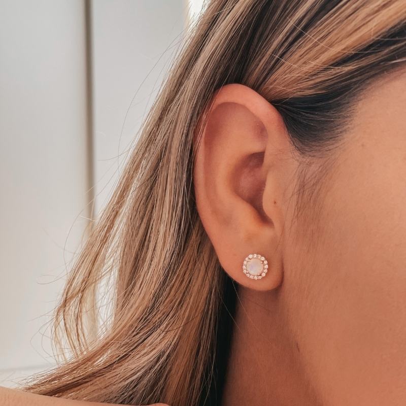 Close-up of a woman's ear wearing a Keira Rose Silver Earring with a moonstone.