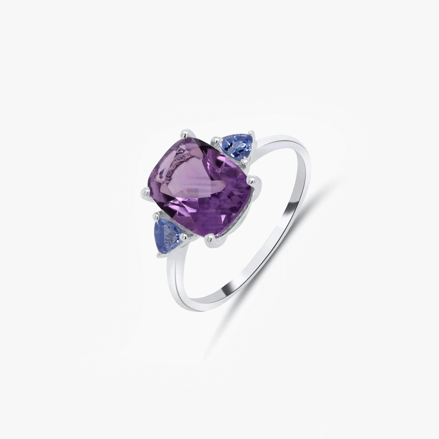 Silver ring featuring a large amethyst stone with two smaller tanzanite stones set in a minimalist design.