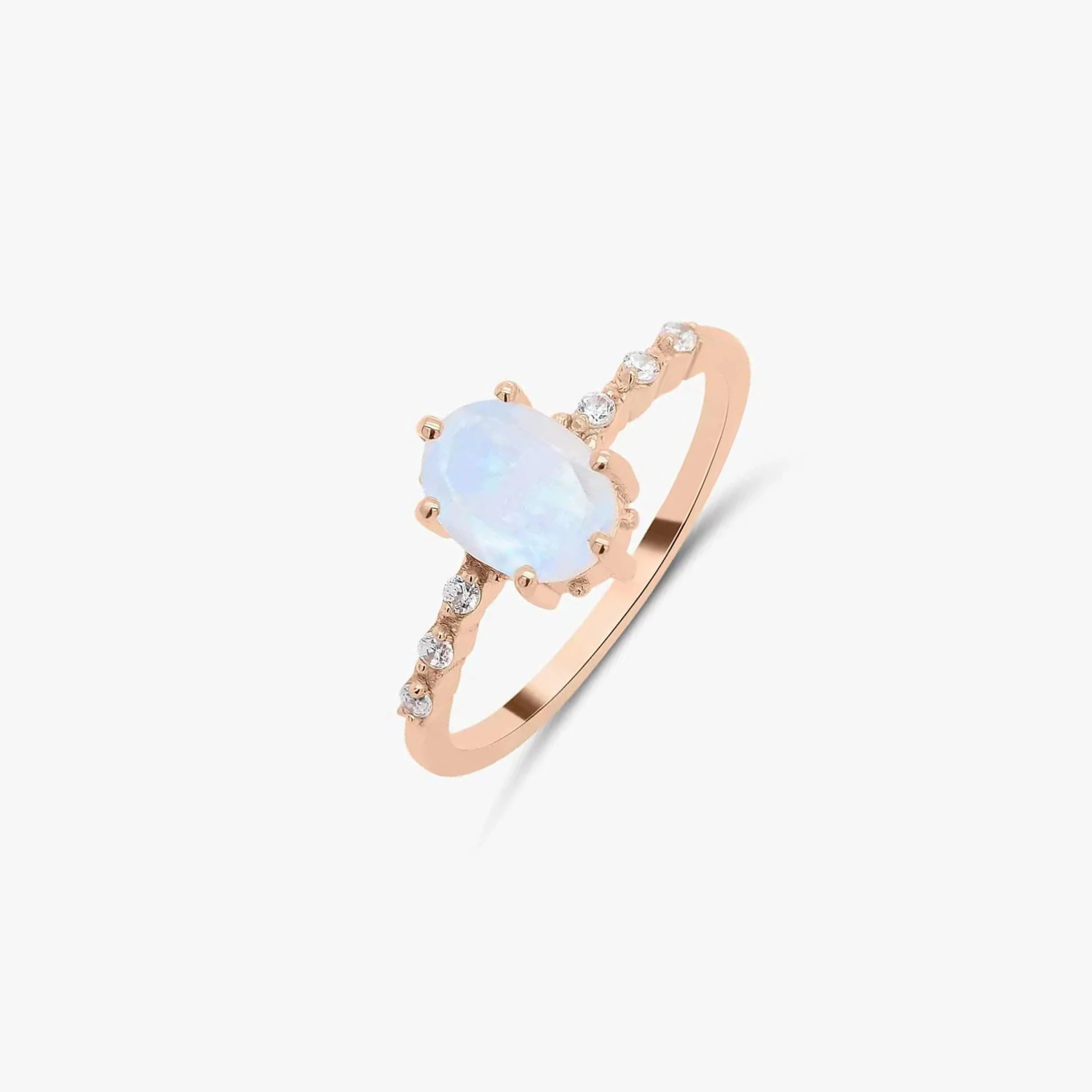 Rose gold ring with moonstone and zircon embellishments on a solid white background.