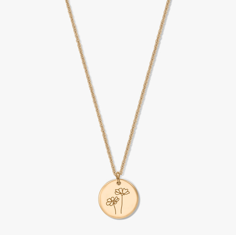 Gold-plated silver necklace with a round disc pendant engraved with two cosmos flowers, photographed on a white background.