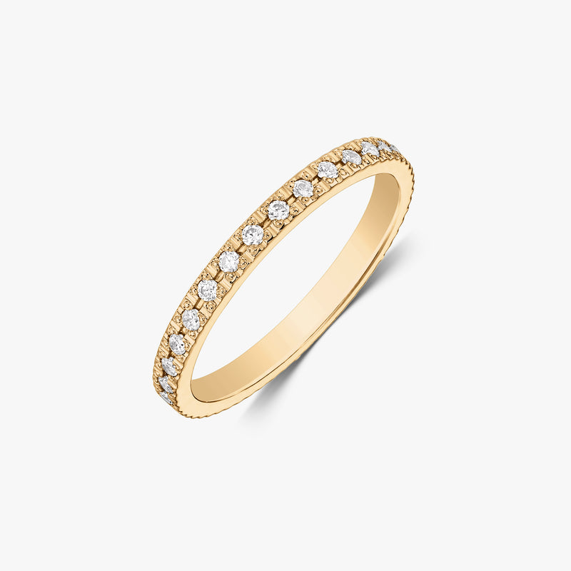 14K yellow gold zirconia tennis wedding band with round white stones, photographed on a white background.