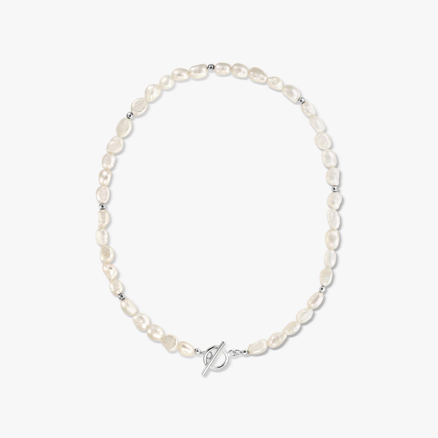 Centered studio photo of a silver toggle‑clasp necklace with natural white baroque pearls on a solid white background.