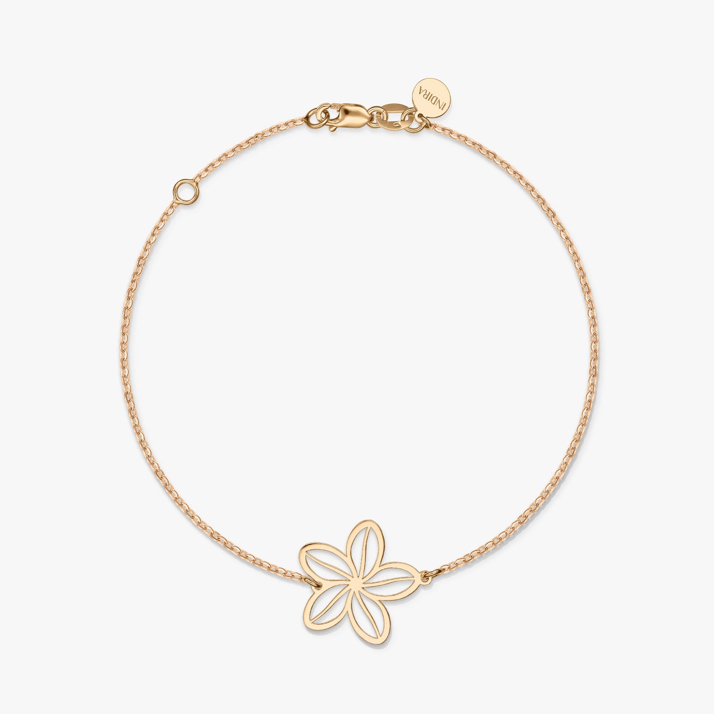 A minimalist gold bracelet featuring a delicate flower charm on a solid white background.