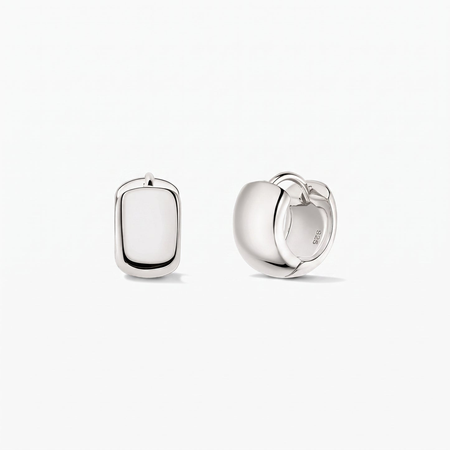 Bold Mini Hoops Silver Earrings in 925 sterling silver by Indira, shown on a white background with one earring front-facing and the other side view displaying the hinged clasp.