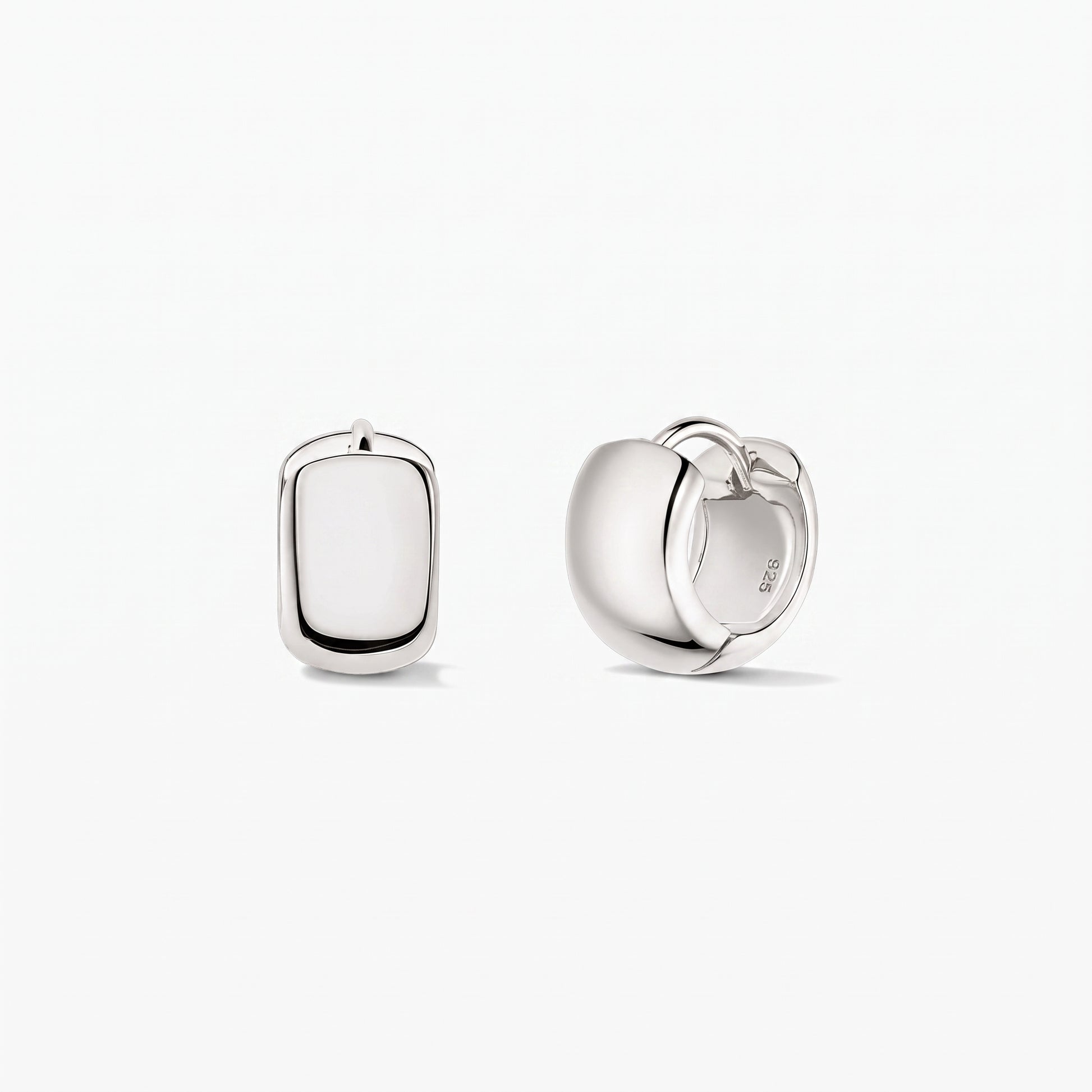 Bold Mini Hoops Silver Earrings in 925 sterling silver by Indira, shown on a white background with one earring front-facing and the other side view displaying the hinged clasp.