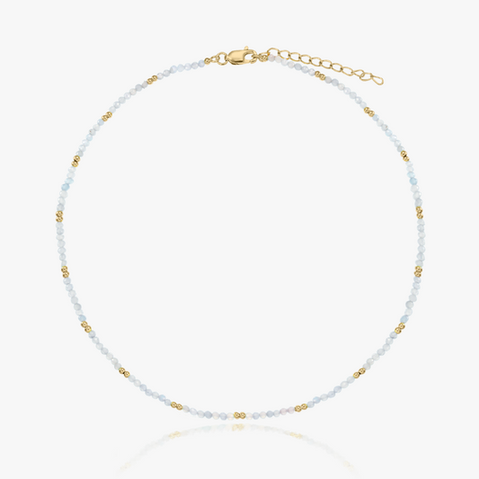 Delicate moonstone beaded necklace with tiny gold accents and an adjustable gold‑plated clasp, shown on a white background.