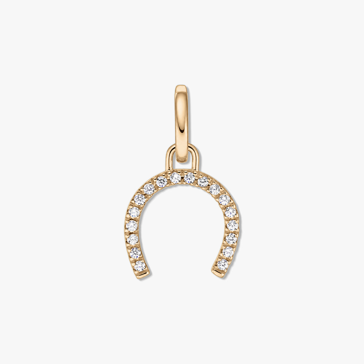 Gold-tone horseshoe silver pendant with pavé clear zirconia stones on a white background.