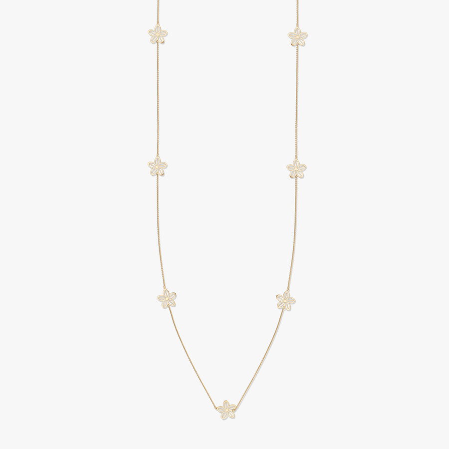 Gold necklace with floral motifs on a white background