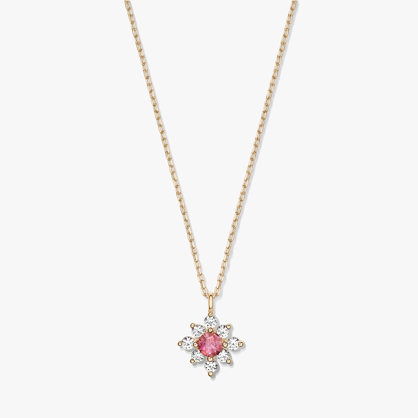 14K gold necklace with a floral pendant featuring a pink tourmaline center surrounded by white sapphires on a white background.