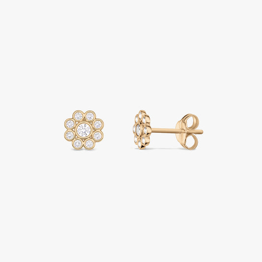 Pair of daisy-shaped 14K yellow gold stud earrings with white cubic zirconia, shown front and side on a white background.