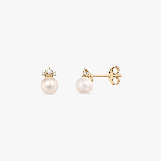 Pair of 14k yellow gold stud earrings with round natural pearls and small white zirconia crown accents, shown front and side on a white background.