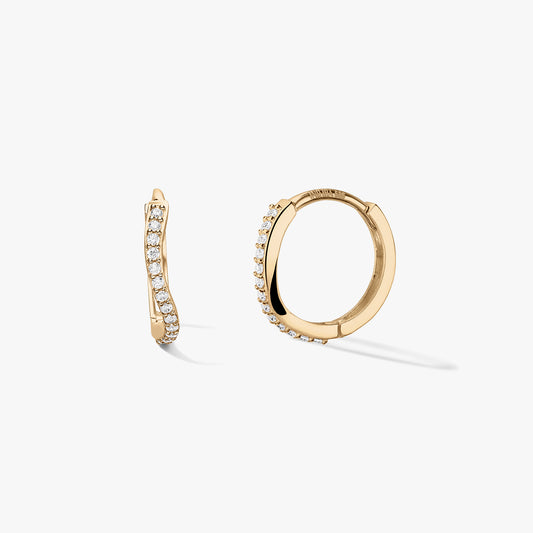 Pair of 14k yellow gold huggie hoop earrings with a wavy pavé row of white zirconia, shown on a clean white background—one side view and one open hoop to show the closure.
