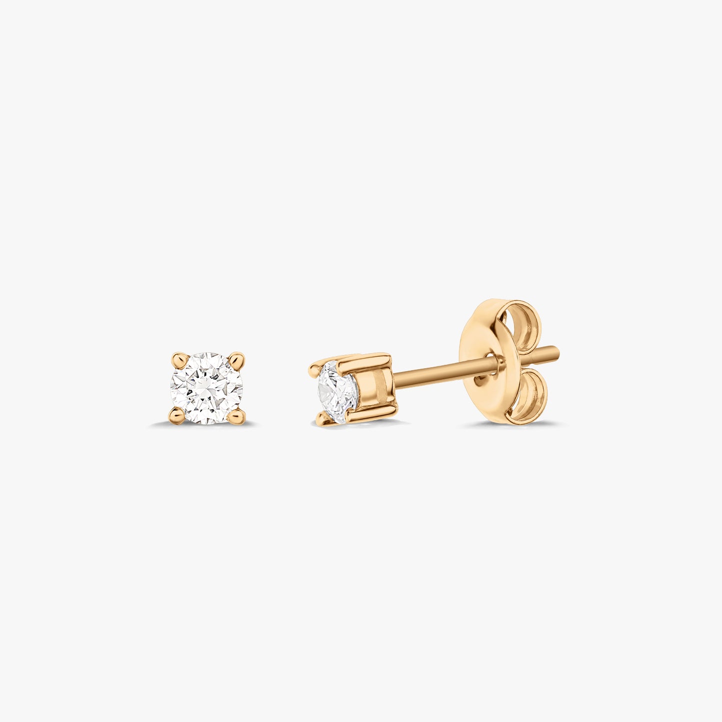 Pair of gold stud earrings each featuring a solitaire diamond, set on a white background.