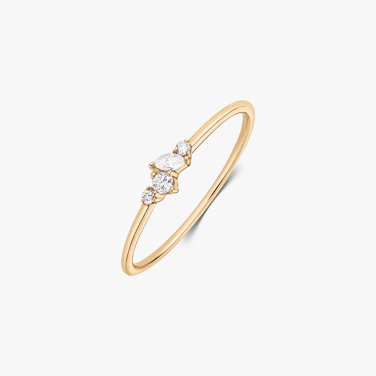 Nova 14K yellow gold ring with a delicate cluster of five white diamonds on a slim band, shown on a white background.
