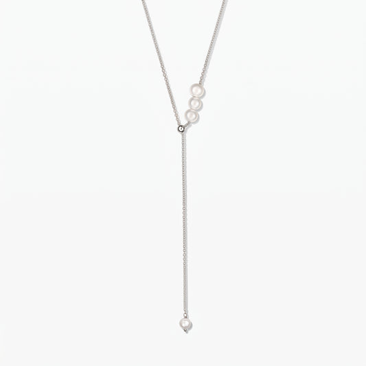 Adjustable sterling silver lariat necklace with white cultured pearls, centered on a white background.