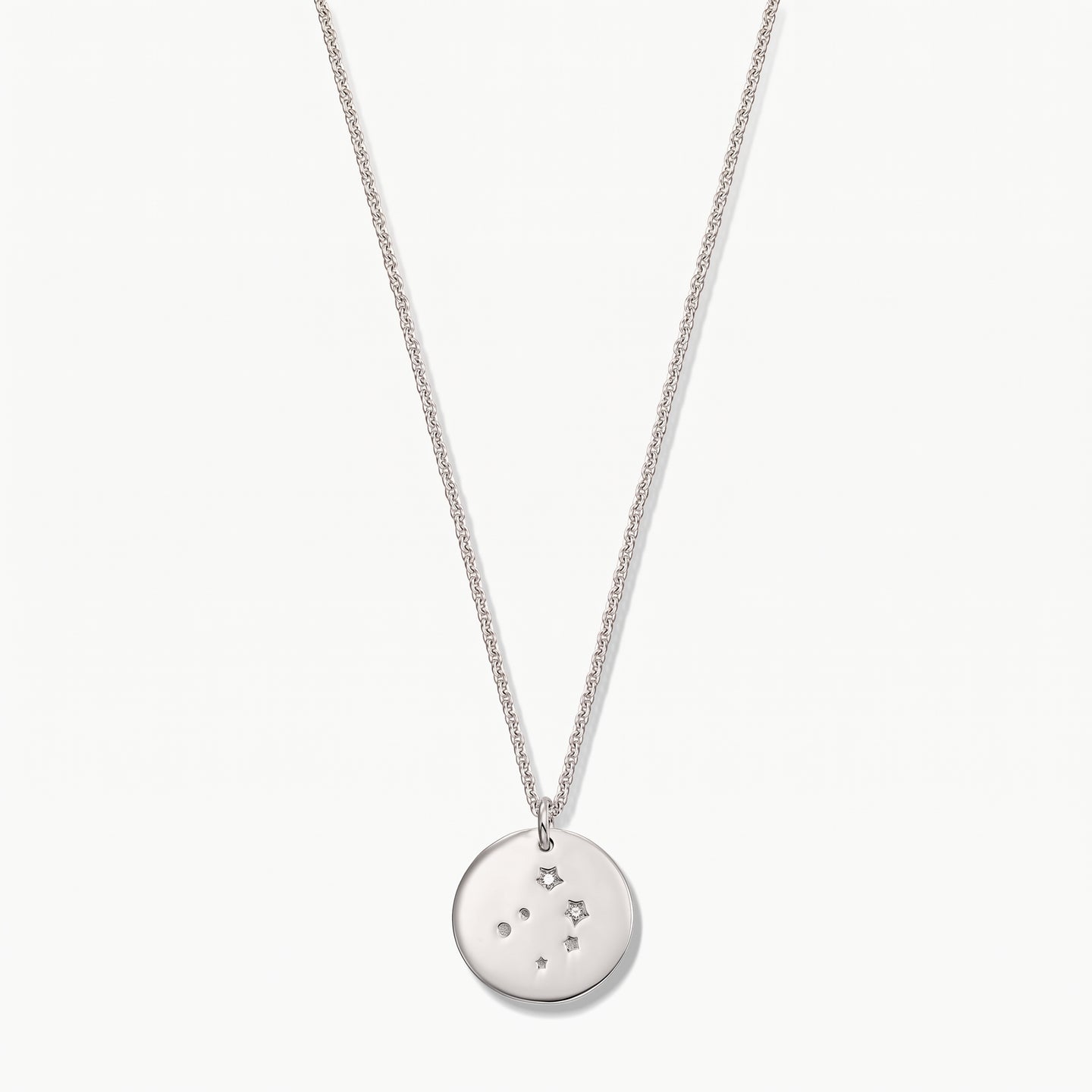 Sterling silver Libra zodiac coin necklace with white sapphire accents on a delicate chain, photographed on a white background.