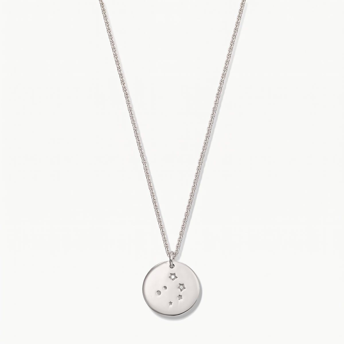 Sterling silver Libra zodiac coin necklace with white sapphire accents on a delicate chain, photographed on a white background.