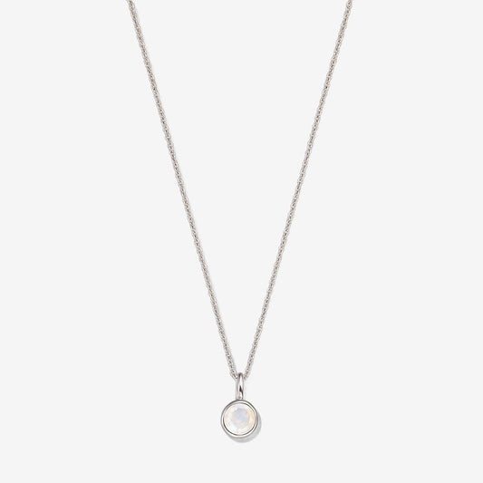 Sterling silver necklace with a small round bezel‑set moonstone pendant on a fine chain, photographed on a white background.