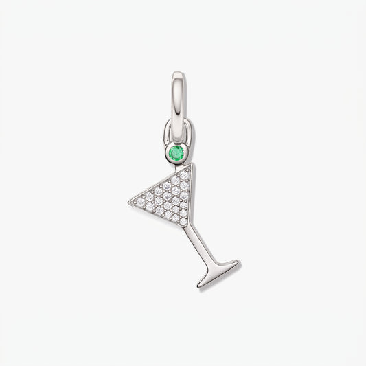 Silver cocktail glass pendant with white zirconia pavé and a small green accent stone on a clean white background.