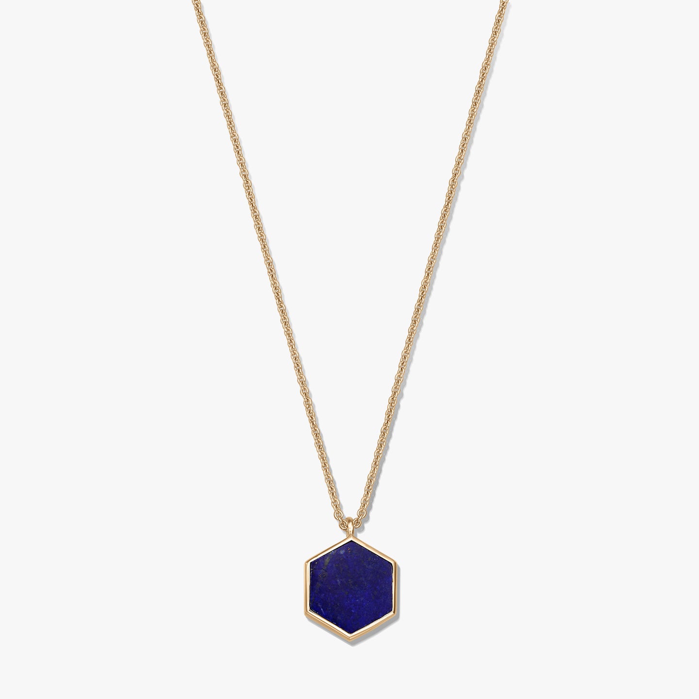 Gold-plated sterling silver necklace with a hexagon lapis lazuli pendant on a white background.