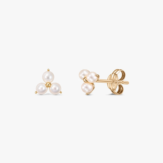 Pair of Pointe gold stud earrings with three white cultured pearls clustered in a triangle on a white background, shown front and side with butterfly backs.