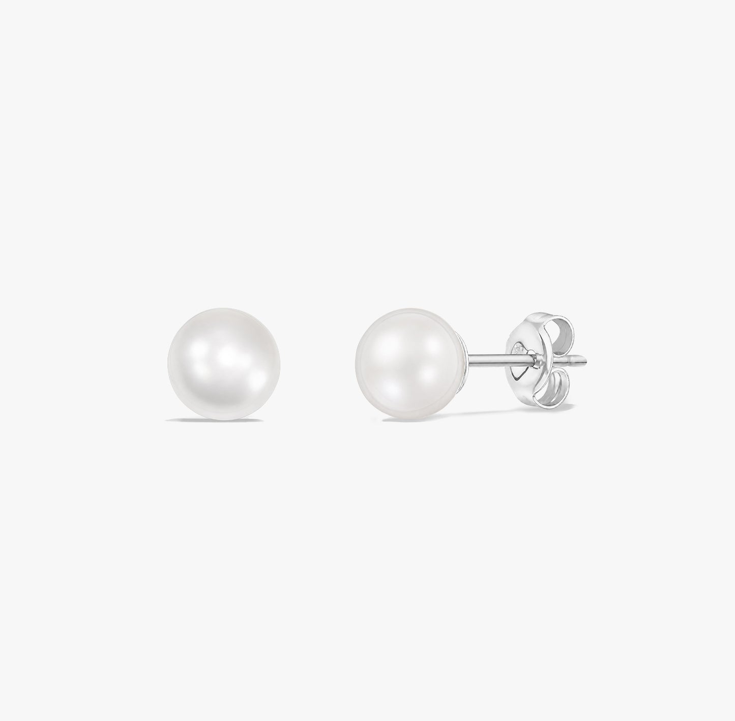 Pair of classic pearl stud earrings with natural white pearls set in 925 sterling silver on a white background.