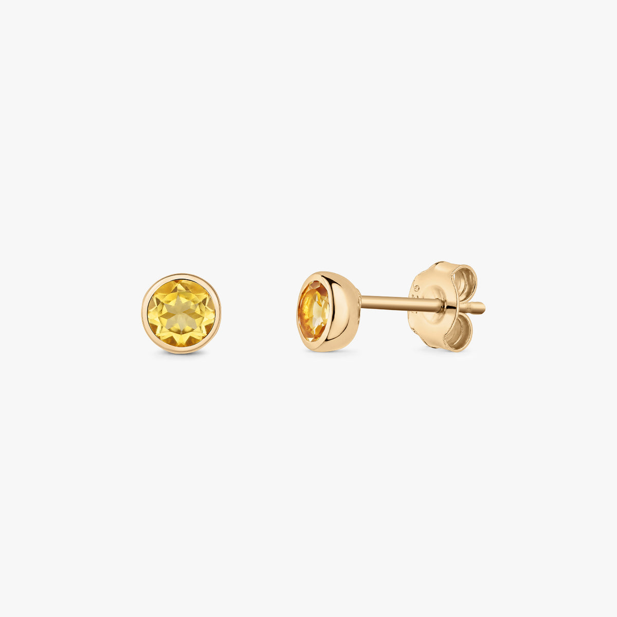 Pair of silver stud earrings with round citrine birthstones in bezel settings on a white background, showing front and side views with butterfly backs.