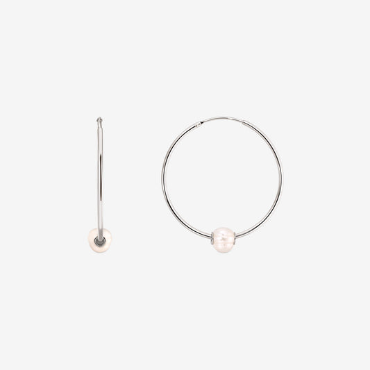 Pair of sterling silver hoop earrings with a single white cultured pearl on each, shown on a white background with one earring front view and one side view.