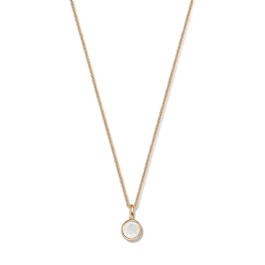 Dainty gold‑plated sterling silver necklace with a round bezel‑set moonstone pendant on a black background.