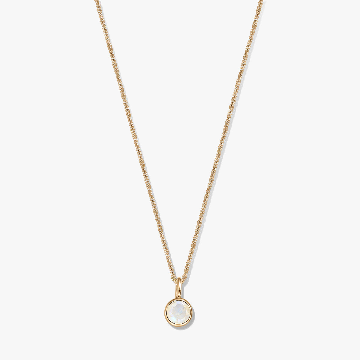 Gold-plated sterling silver necklace with a small round bezel-set moonstone birthstone pendant, centered on a white background.