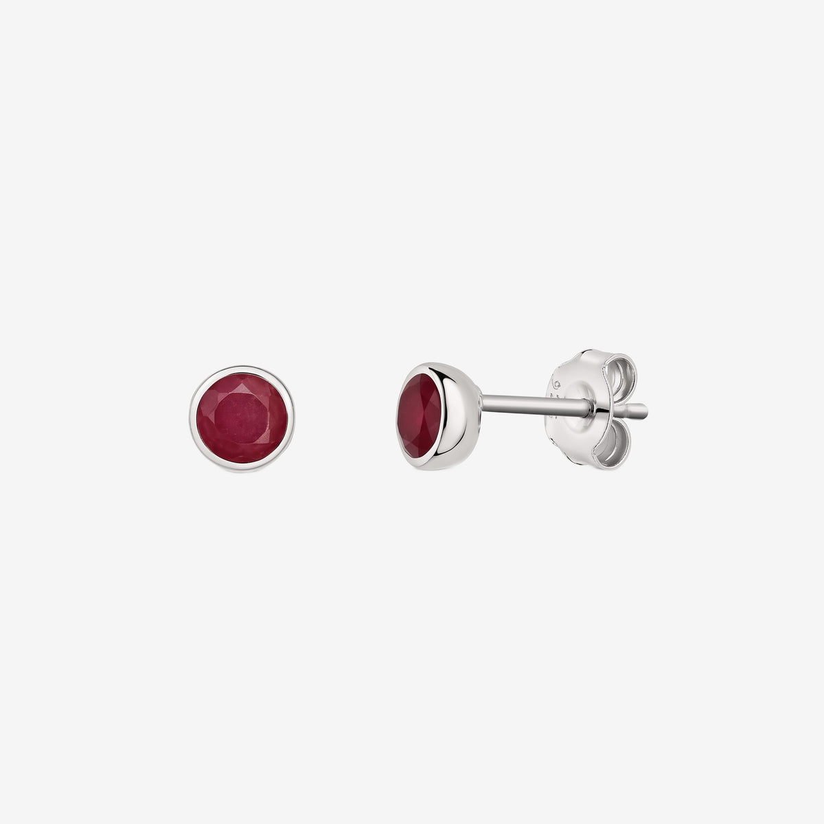 Pair of silver bezel-set ruby stud earrings shown on a white background, with front and side views.