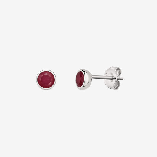 Pair of silver bezel-set ruby stud earrings shown on a white background, with front and side views.