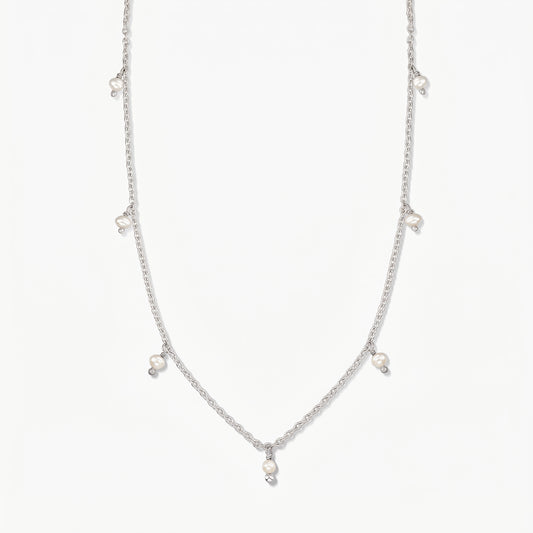 Indira Margot silver necklace with small natural pearl drops, photographed on a clean white background.