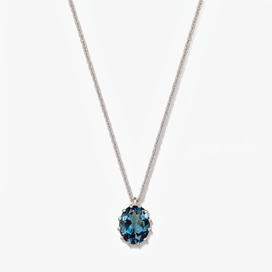 Sterling silver necklace with an oval London blue topaz pendant on a white background.