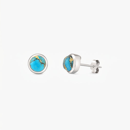 Pair of sterling silver stud earrings featuring round blue copper turquoise cabochons in bezel settings on a white background.