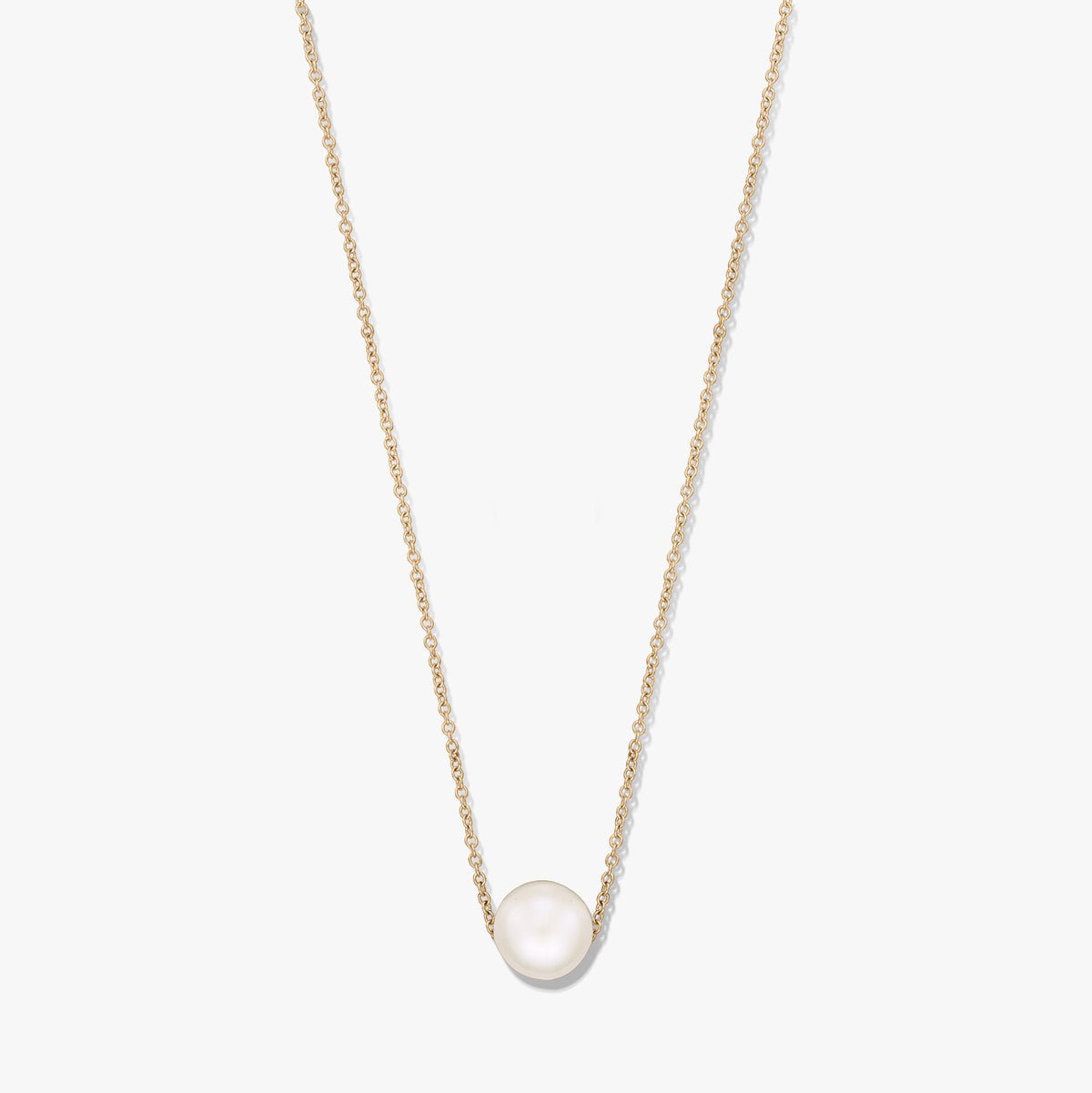 Delicate chain necklace with a single natural white pearl centered on a gold‑tone chain, isolated on a white background.